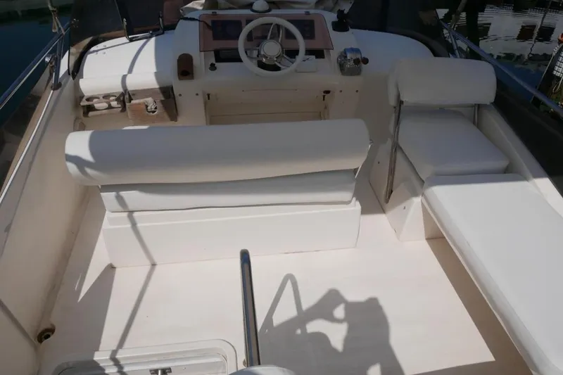  Yacht Photos Pics 1994 Fairline Phantom 37 yacht cockpit with white seating and steering wheel.