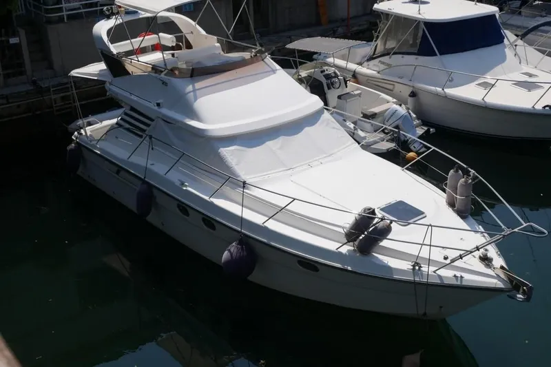  Yacht Photos Pics 1994 Fairline Phantom 37 yacht docked in marina, featuring sleek design and white exterior.