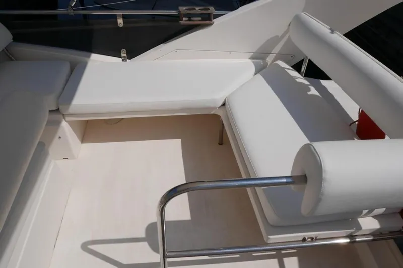 Yacht Photos Pics Interior seating of 1994 Fairline Phantom 37 yacht with white cushions and metal railing.