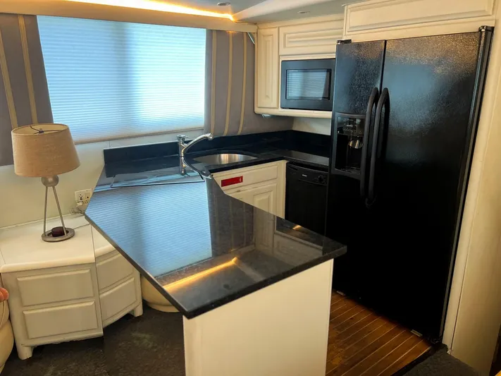 Sea Tiger Yacht Photos Pics Kitchen area of a 1996 Viking 60 Cockpit Sport Yacht with modern appliances.