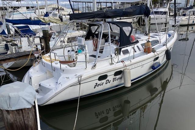 2000 Hunter 380 sailboat named "Joie De Vivre" docked in a marina.