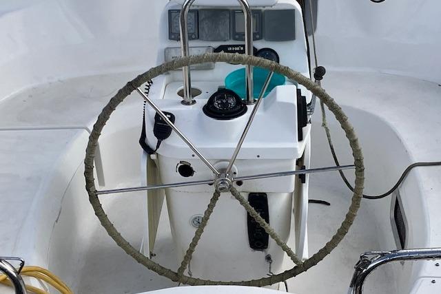 Steering wheel of a 2000 Hunter 380 sailboat with navigation instruments.