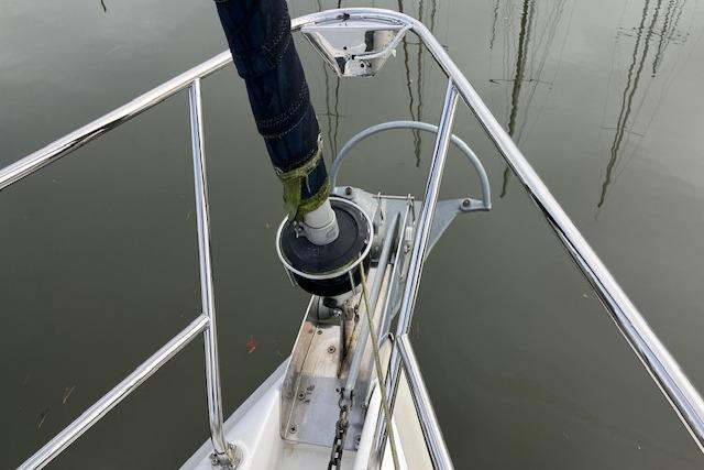 Bow of 2000 Hunter 380 sailboat with anchor chain and railing.