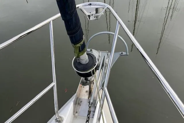 Bow of 2000 Hunter 380 sailboat with anchor chain and railing.
