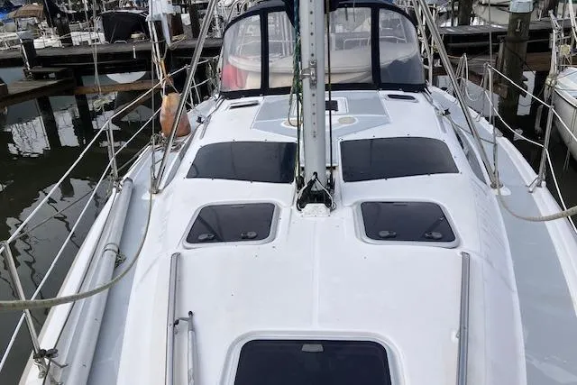 Hunter 380 sailboat, 2000 model, docked at marina with sleek white deck design.