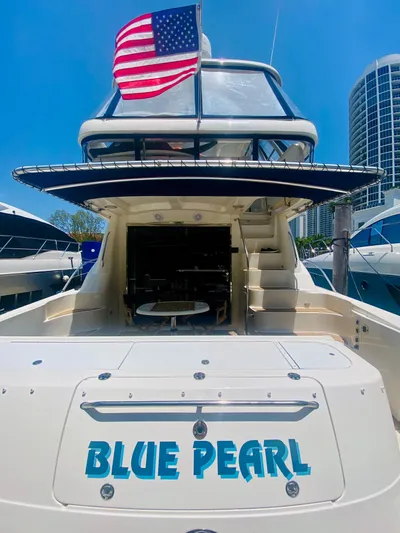 Blue Pearl Yacht Photos Pics 2006 Sea Ray 580 Sedan Bridge yacht "Blue Pearl" with American flag, docked in marina.