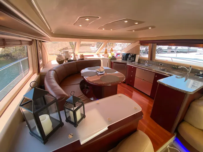 Blue Pearl Yacht Photos Pics Luxurious interior of 2006 Sea Ray 580 Sedan Bridge yacht with elegant seating and kitchen area.