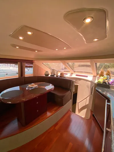 Blue Pearl Yacht Photos Pics Luxurious interior of 2006 Sea Ray 580 Sedan Bridge yacht with elegant seating and wood flooring.