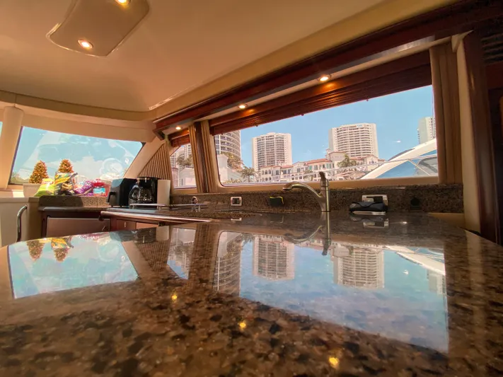 Blue Pearl Yacht Photos Pics Luxurious interior of 2006 Sea Ray 580 Sedan Bridge yacht with cityscape view.