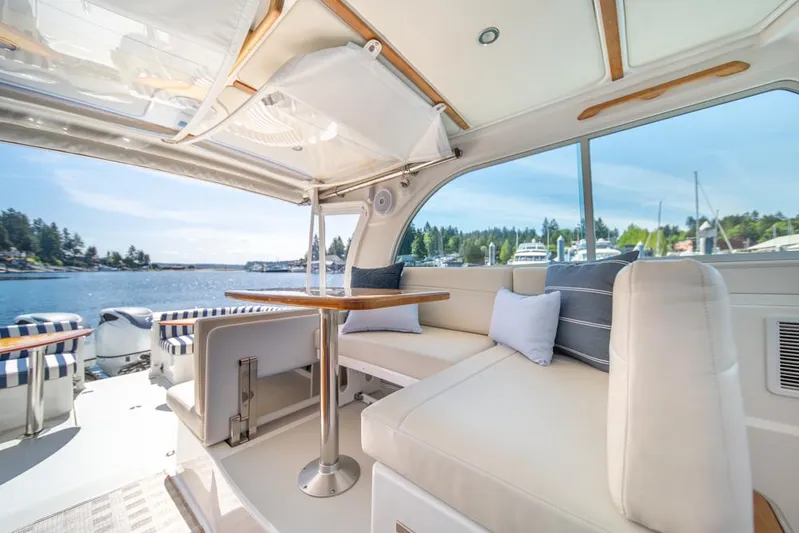 Eastern Standard Yacht Photos Pics Interior of 2021 Back Cove 34O yacht with elegant seating and scenic water view.