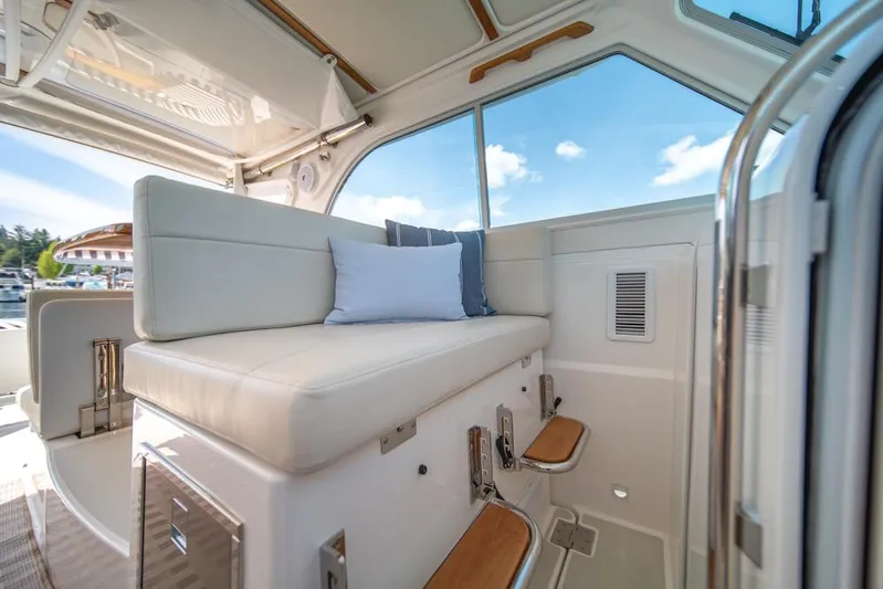 Eastern Standard Yacht Photos Pics 2021 Back Cove 34O interior with cushioned seating and scenic window view.