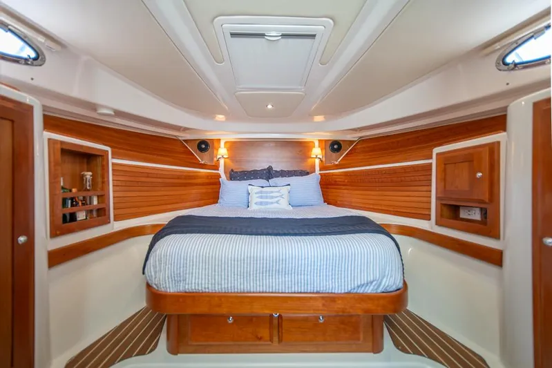 Eastern Standard Yacht Photos Pics 2021 Back Cove 34O cabin interior with cozy bed and wooden accents.