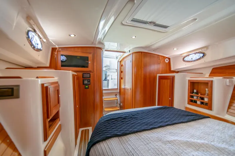 Eastern Standard Yacht Photos Pics Luxurious cabin interior of 2021 Back Cove 34O with wood accents and cozy bedding.