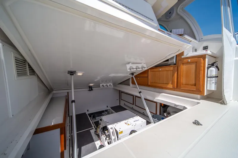 Eastern Standard Yacht Photos Pics 2021 Back Cove 34O engine compartment with open hatch, showcasing interior mechanics and storage.