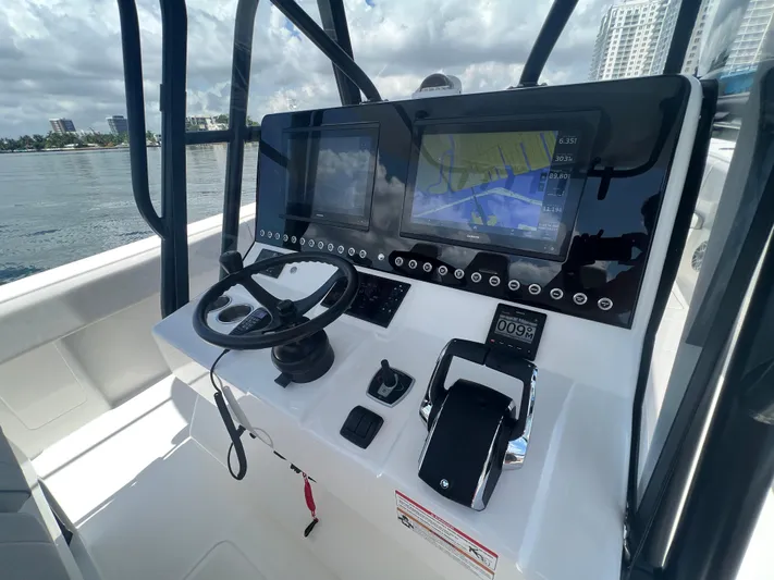  Yacht Photos Pics 2024 SeaVee 390Z boat dashboard with navigation screens and steering wheel.