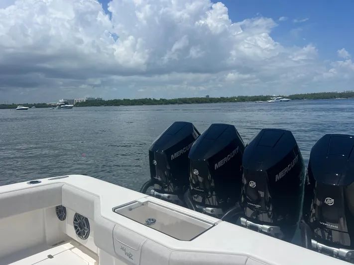  Yacht Photos Pics 2024 SeaVee 390Z boat with four Mercury engines on a calm water backdrop.