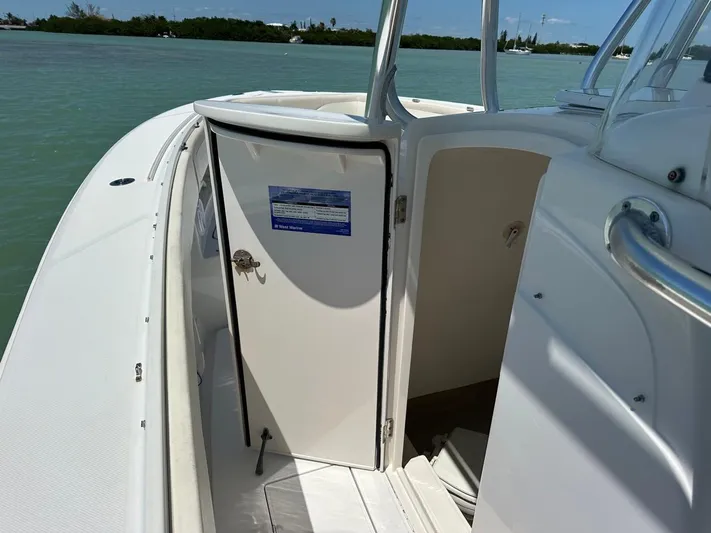  Yacht Photos Pics 2009 Jupiter 29 FS CC boat interior with open cabin door, on calm water.