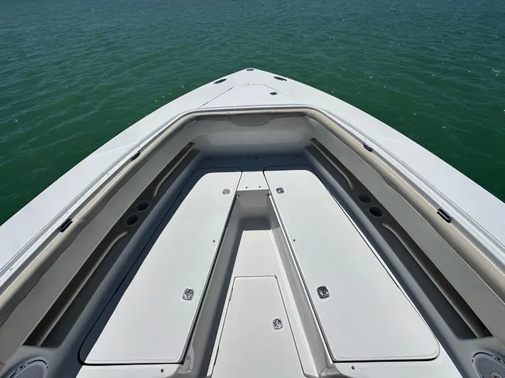  Yacht Photos Pics 2009 Jupiter 29 FS CC boat deck with storage compartments on calm water.