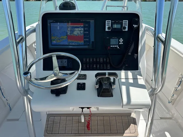  Yacht Photos Pics 2009 Jupiter 29 FS CC boat console with navigation equipment and steering wheel.