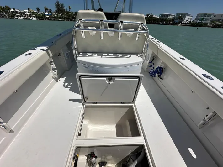  Yacht Photos Pics 2009 Jupiter 29 FS CC boat interior with open storage compartments on calm water.