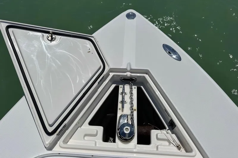  Yacht Photos Pics 2009 Jupiter 29 FS CC boat anchor compartment with open hatch, showing chain and winch.