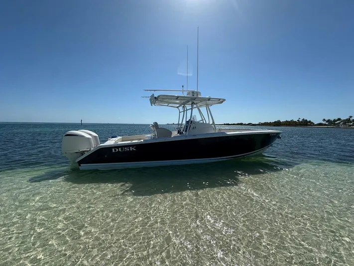  Yacht Photos Pics 2009 Jupiter 29 FS CC boat anchored in clear shallow water under a bright blue sky.