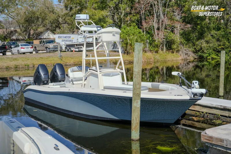  Yacht Photos Pics 2016 Young 27 boat docked at a serene lakeside, featuring dual engines.