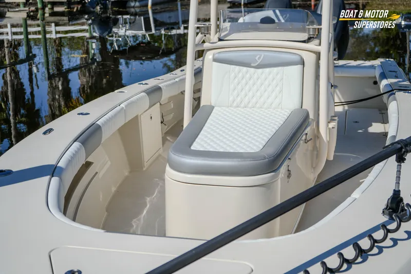  Yacht Photos Pics 2016 Young 27 boat with cushioned seating, docked at a marina.