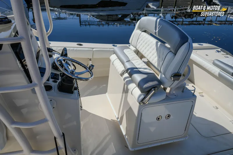  Yacht Photos Pics 2016 Young 27 boat interior with steering wheel and cushioned seating.
