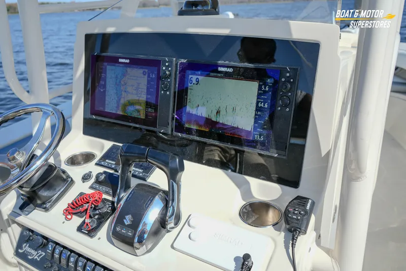  Yacht Photos Pics Boat dashboard with dual Simrad displays, steering wheel, and controls on a 2016 Young 27 model.