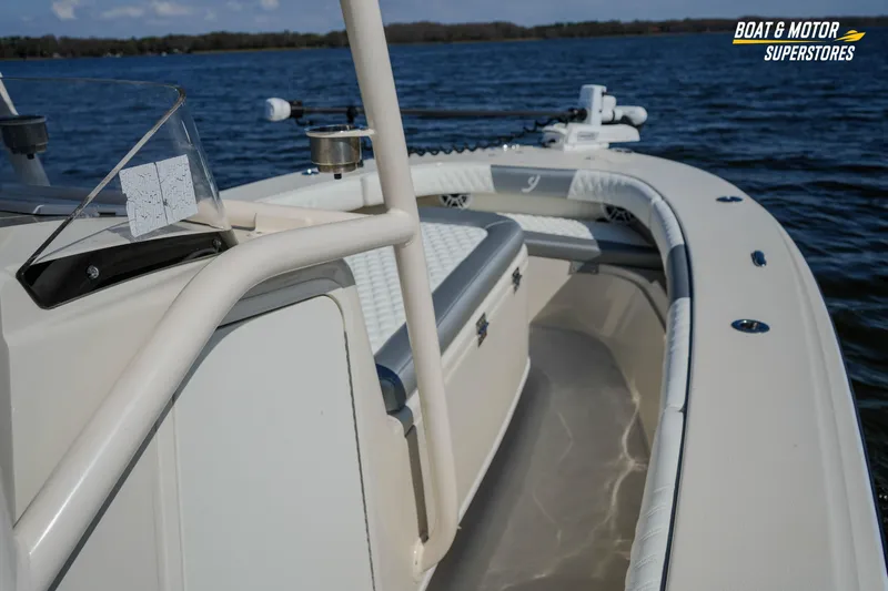  Yacht Photos Pics Interior view of a 2016 Young 27 boat on a lake, featuring seating and railing.