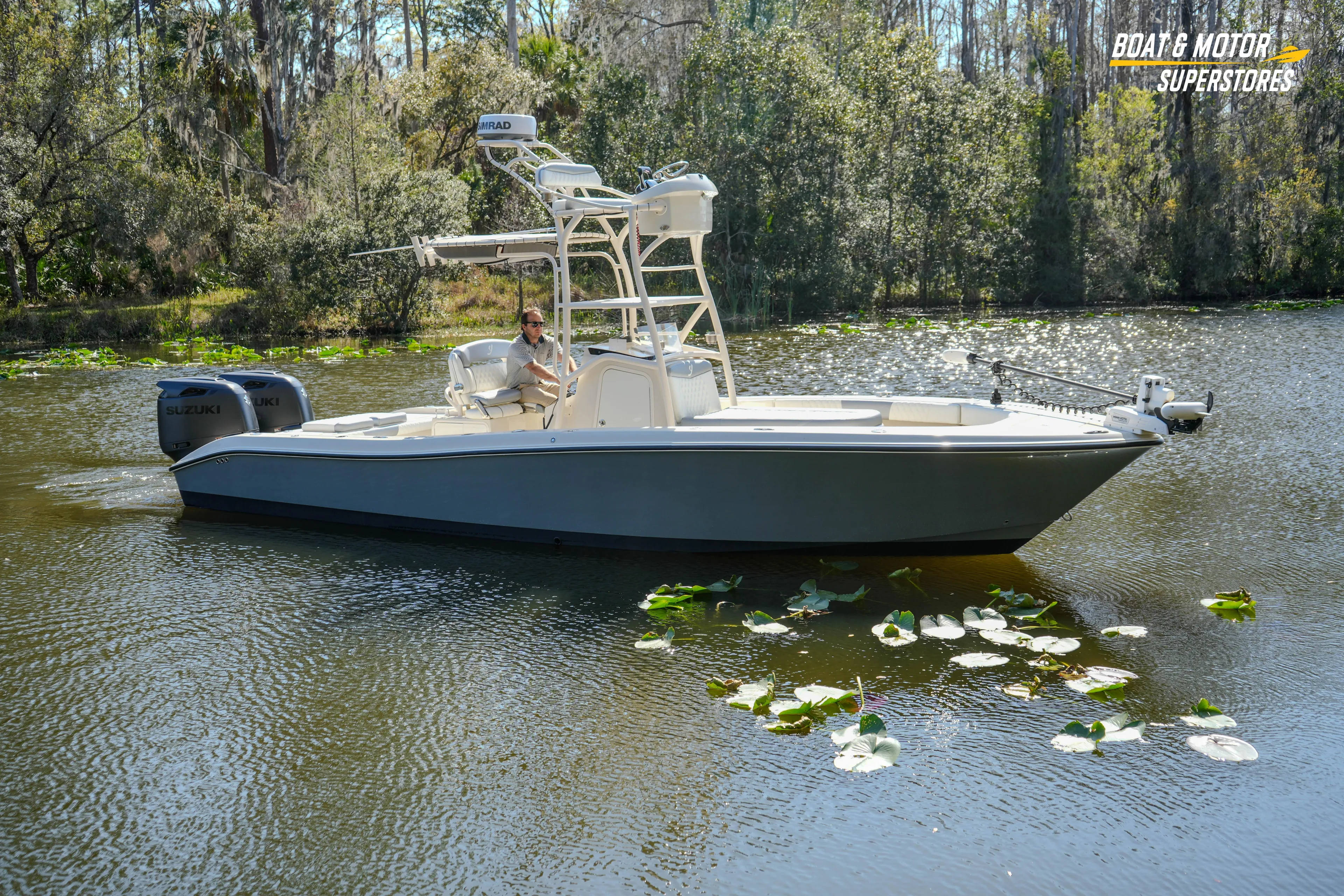  Yacht Photos Pics Boat on a serene lake, Young 27 model, 2016, surrounded by lush greenery.