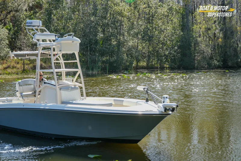  Yacht Photos Pics A 2016 Young 27 boat navigating a serene, tree-lined waterway.