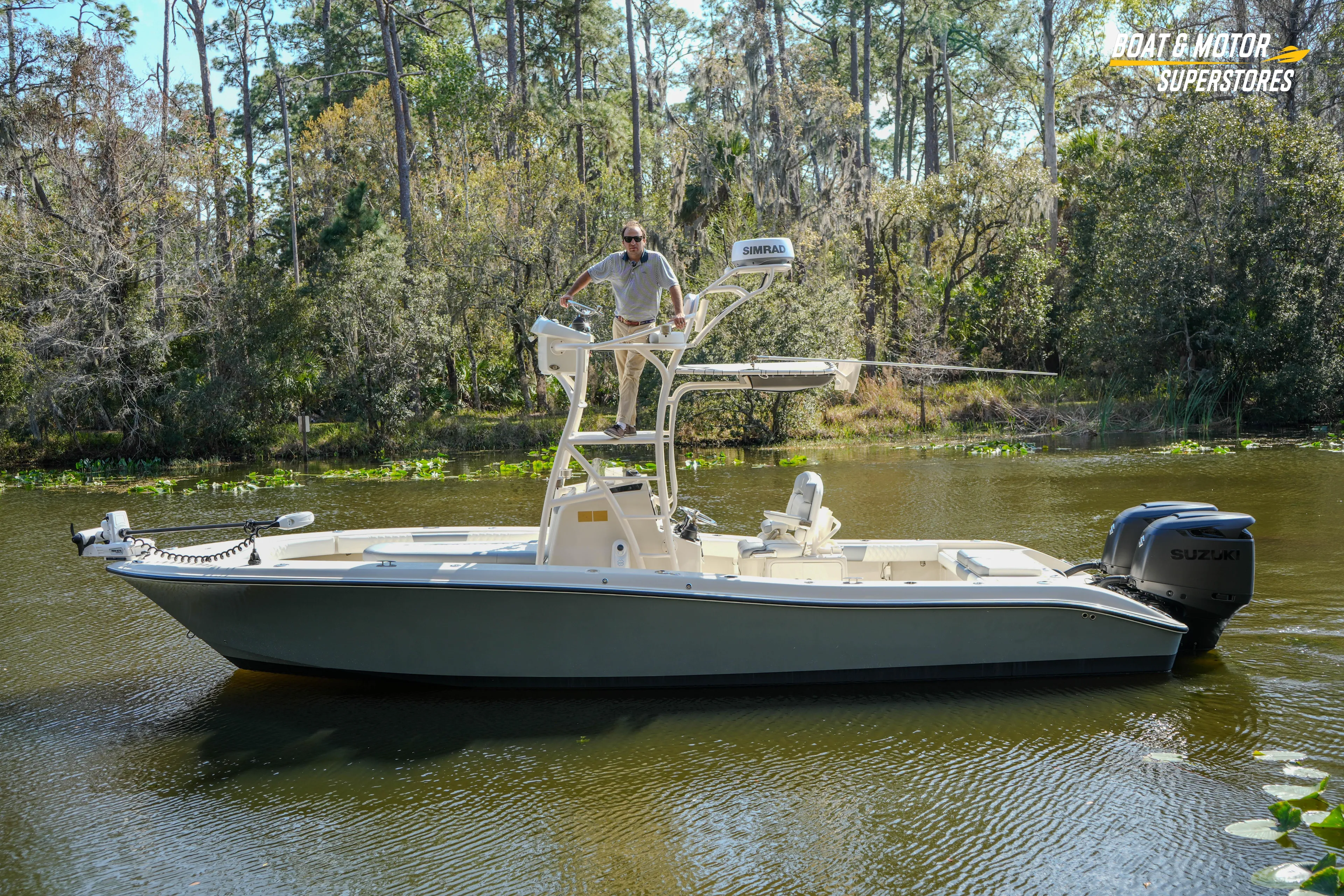  Yacht Photos Pics Man on 2016 Young 27 boat with Suzuki motor in scenic river setting.