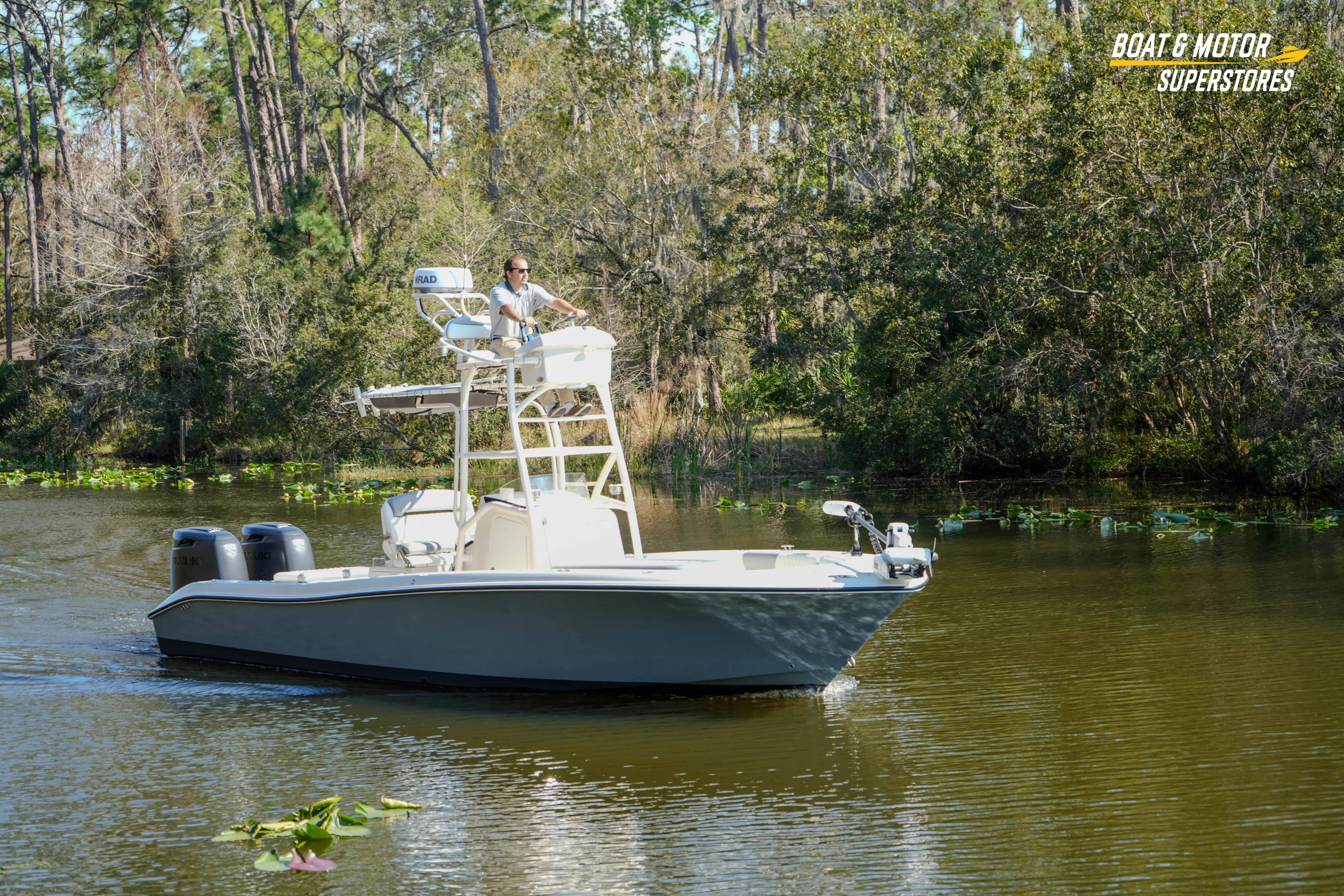  Yacht Photos Pics Boat navigating a serene lake surrounded by lush trees, featuring a 2016 Young 27 model.