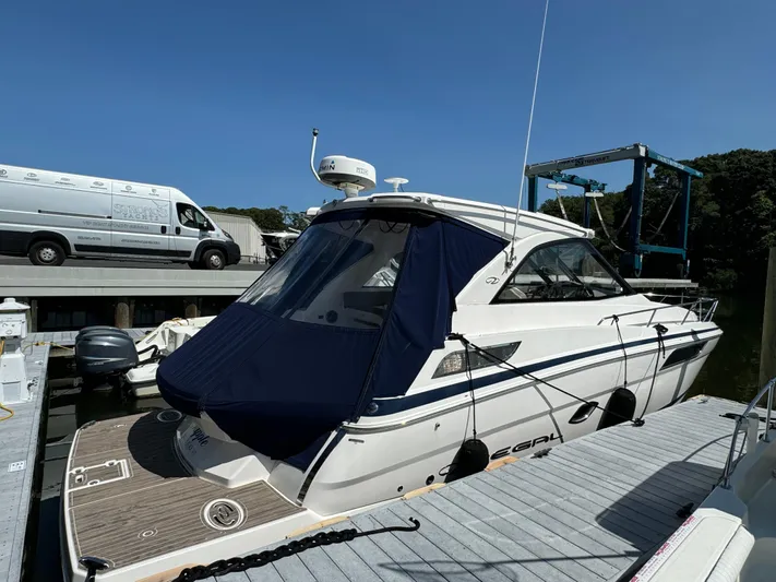 Ripple Yacht Photos Pics 2016 Regal 35 Sport Coupe docked at marina under clear blue sky.