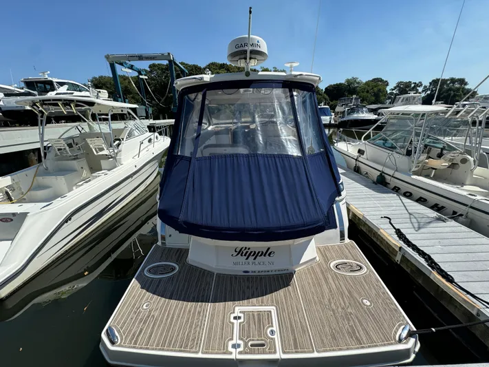 Ripple Yacht Photos Pics 2016 Regal 35 Sport Coupe docked at marina with blue cover.