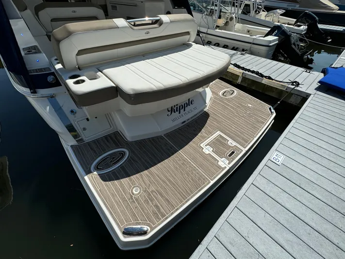 Ripple Yacht Photos Pics 2016 Regal 35 Sport Coupe boat with spacious swim platform at dock.