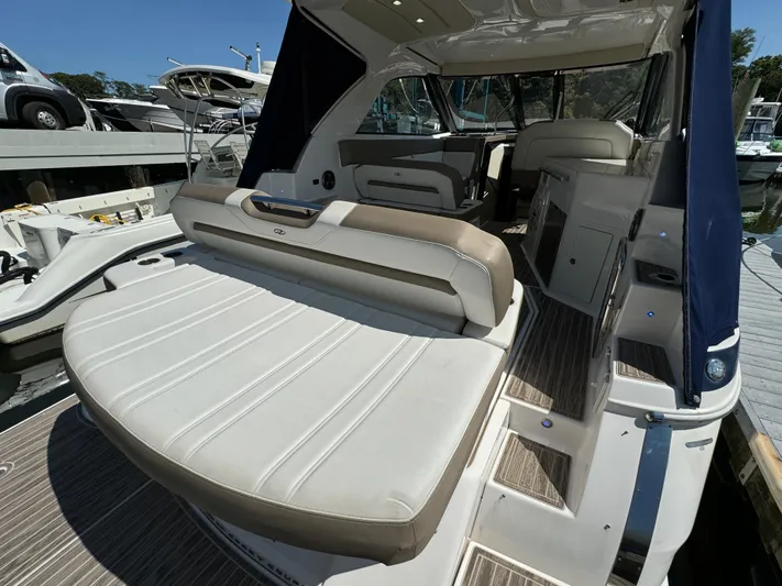 Ripple Yacht Photos Pics 2016 Regal 35 Sport Coupe boat interior with seating and steps, docked at marina.