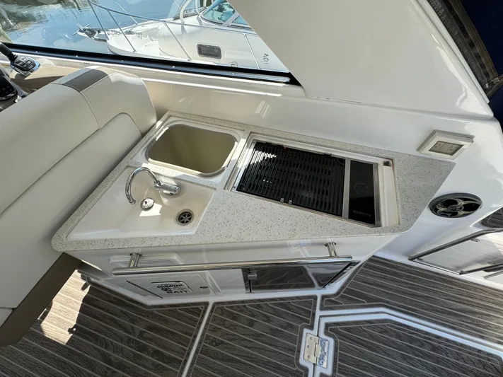 Ripple Yacht Photos Pics 2016 Regal 35 Sport Coupe interior with kitchenette and sink.