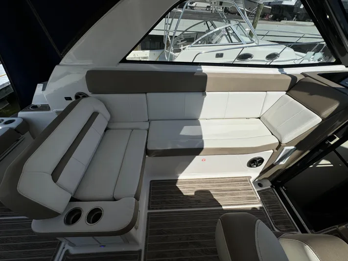 Ripple Yacht Photos Pics 2016 Regal 35 Sport Coupe interior with beige seating and wood flooring.