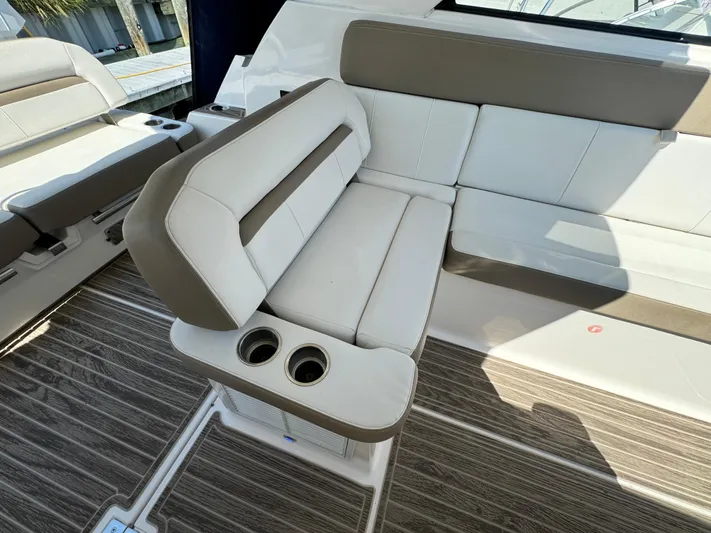 Ripple Yacht Photos Pics 2016 Regal 35 Sport Coupe interior seating with cup holders, featuring beige and white upholstery.