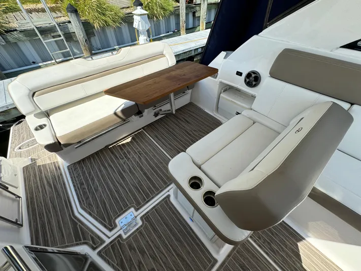 Ripple Yacht Photos Pics 2016 Regal 35 Sport Coupe interior with seating and wooden table.