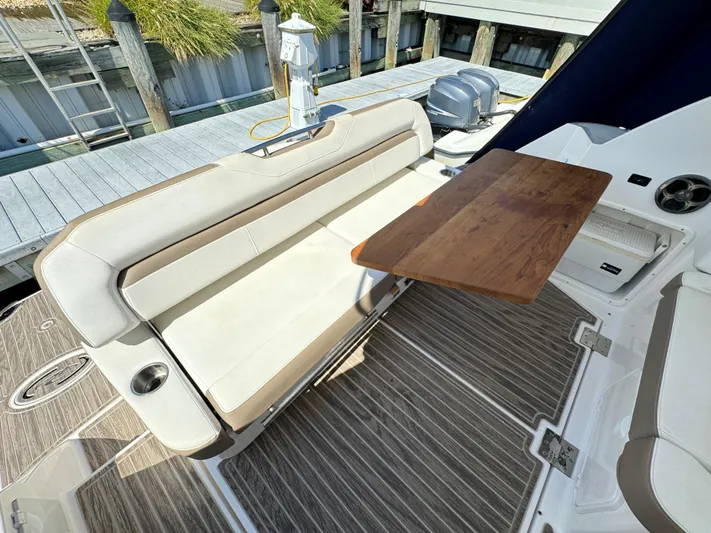 Ripple Yacht Photos Pics 2016 Regal 35 Sport Coupe interior with beige seating and wooden table.