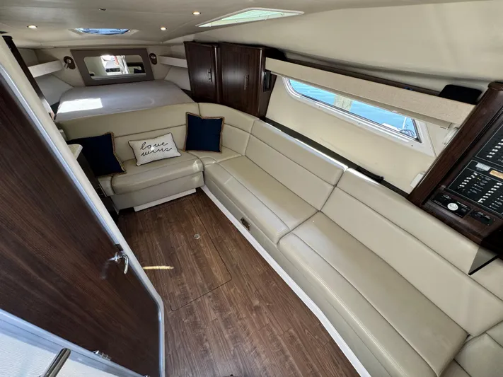 Ripple Yacht Photos Pics Luxurious interior of 2016 Regal 35 Sport Coupe with beige seating and wood accents.