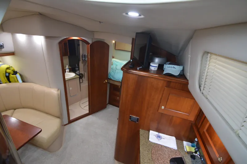 Side Chick Yacht Photos Pics Interior of 2002 Rampage 38 Express yacht with cozy seating and wooden cabinetry.