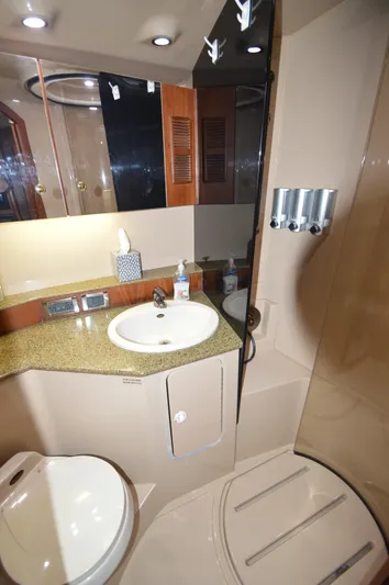 Side Chick Yacht Photos Pics Luxurious bathroom in 2002 Rampage 38 Express yacht with modern fixtures and granite countertop.