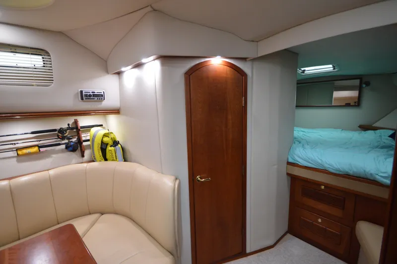 Side Chick Yacht Photos Pics Interior of 2002 Rampage 38 Express yacht with cozy seating and sleeping area.