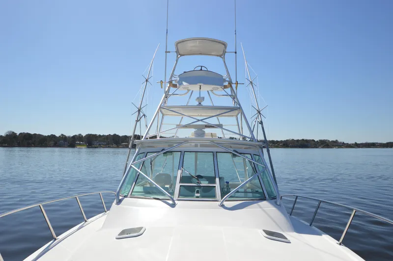 Side Chick Yacht Photos Pics 2002 Rampage 38 Express boat on calm water under clear blue sky.
