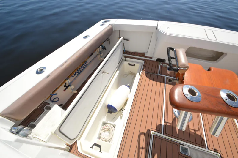 Side Chick Yacht Photos Pics 2002 Rampage 38 Express boat deck with storage compartments and fishing rod holders.